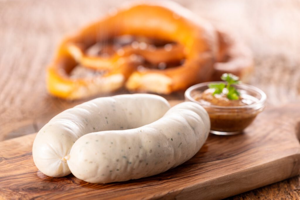 Frühstück auf dem Tisch mit Weißwurst, Breze und Pfannkuchen